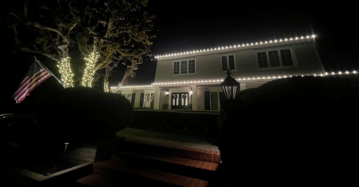 Two-story roofline with wrapped trees